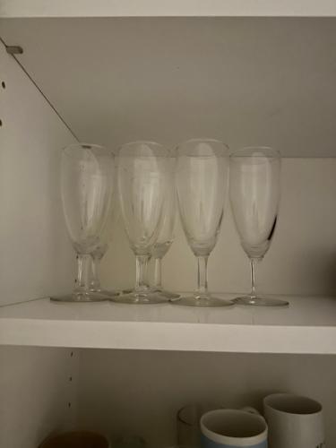 a row of wine glasses sitting on a shelf at Berlin 2BR home in heard of Tornio in Tornio