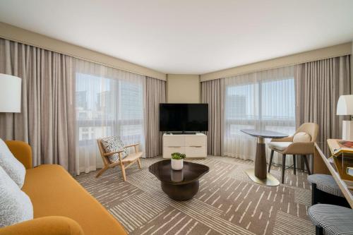 a living room with a couch and a flat screen tv at Hilton San Diego Gaslamp Quarter in San Diego