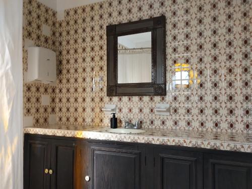 a bathroom with a sink and a mirror at Hotel & Hostal Santuario in San Miguel de Allende