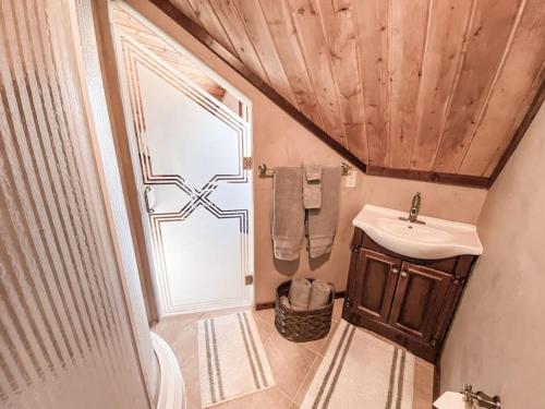a small bathroom with a sink and a toilet at Spectacular Custom Log Cabin with Hot Tub, Epic Views, Fireplace - Moose Tracks Cabin in Fairplay