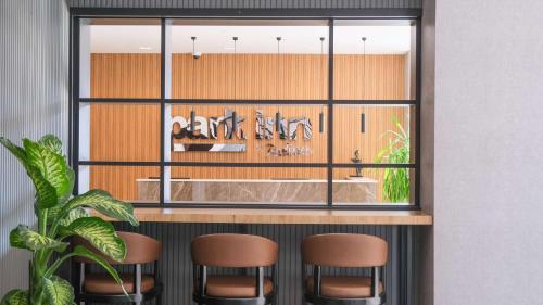 a bar with three stools in front of a window at Park Inn by Radisson Yalova City Center in Yalova