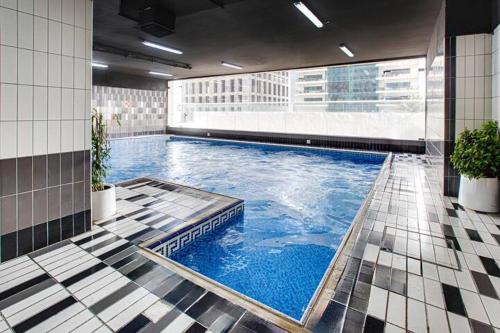 a large swimming pool in the middle of a building at Sea & Marina view, High Floor, Near Beach in Dubai