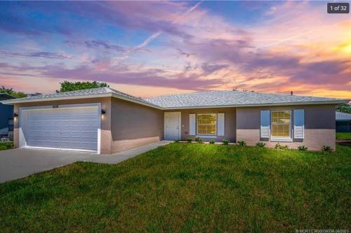 a rendering of a house with a garage at Modern and comfortable new home with hot tub in Fort Pierce