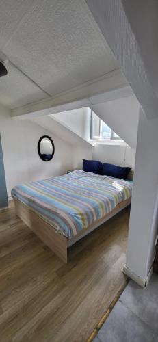 une chambre avec un lit dans une pièce blanche dans l'établissement Cosy studio Clichy Levallois, à Clichy