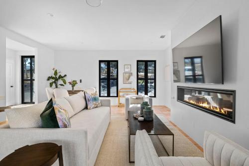 a living room with a couch and a fireplace at Las Luces in Spicewood
