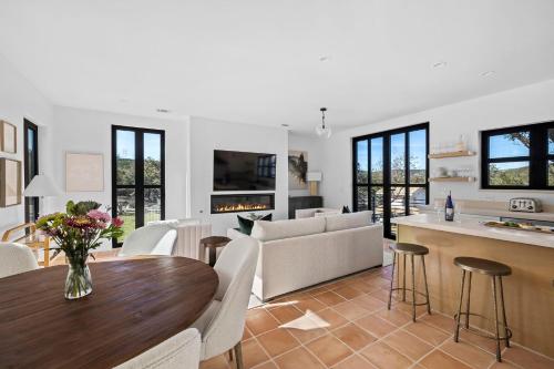 a kitchen and living room with a table and a couch at Las Luces in Spicewood