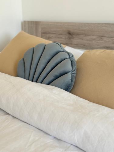 a blue pillow sitting on top of a bed at Trsat-Kampus apartments in Rijeka