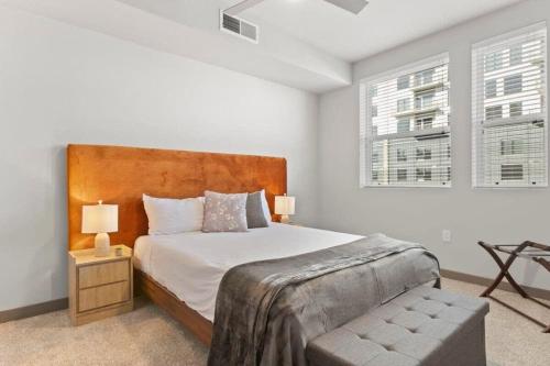 a bedroom with a large bed and two windows at 3BR Cozysuites RORO Pool, Pets, Parking 7&13 in Phoenix