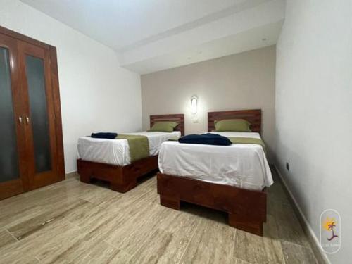 Ένα ή περισσότερα κρεβάτια σε δωμάτιο στο Boca chica Presidential Suites Hamaca
