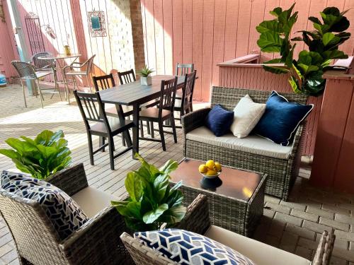 a patio with a table and a couch and chairs at 3 bedroom in Best Location Parking Fireplace Patio Home office Pets Welcome in Chicago