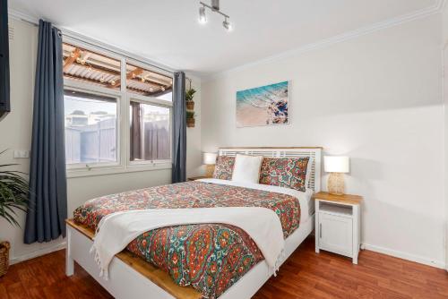 a bedroom with a bed and a window at MOANA I Walk to Beach & River in Ocean Grove
