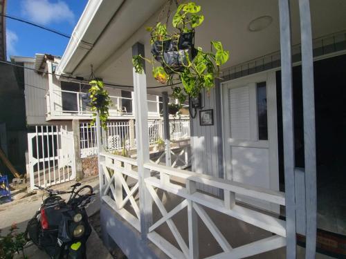 a scooter parked next to a house with a white fence at Posada Hill View in Providencia