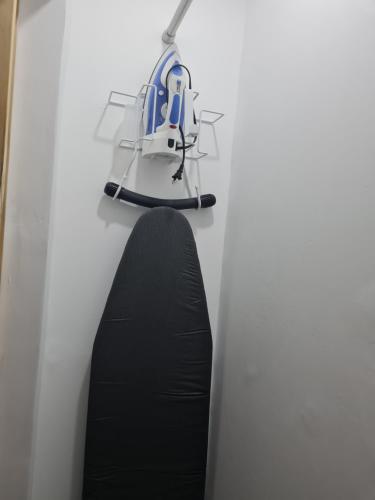 a helmet hanging on a wall next to a black surfboard at Sky Beach Hotel in Hopewell