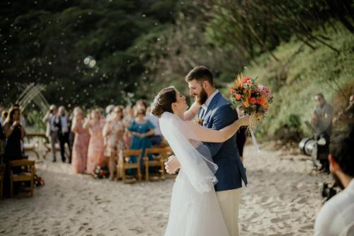 a bride and groom kissing at their wedding on the beach at TreeCasa Hotel & Resort Nicaragua in San Juan del Sur