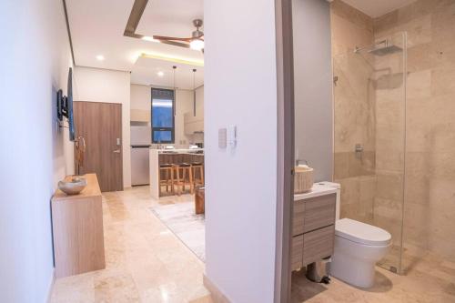 a bathroom with a toilet and a glass shower at Tulum Sea View Rooftop BrandNew 1BR in Tulum
