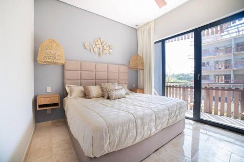 a bedroom with a large bed and a large window at Tulum Sea View Rooftop BrandNew 1BR in Tulum
