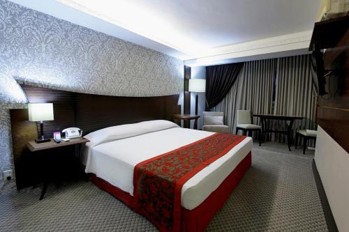 una habitación de hotel con una cama grande y una mesa en Casa dos Belfort, en Barreiras
