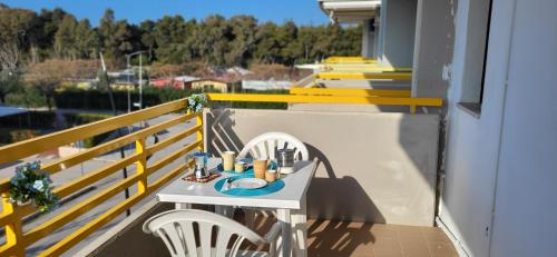 a table and two chairs on a balcony at Il bacio del sole in Campomarino