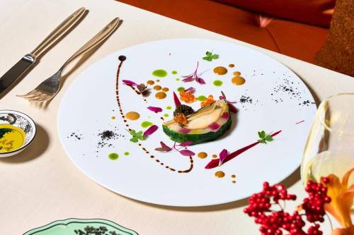 a white plate with food on it on a table at The St. Regis Osaka in Osaka