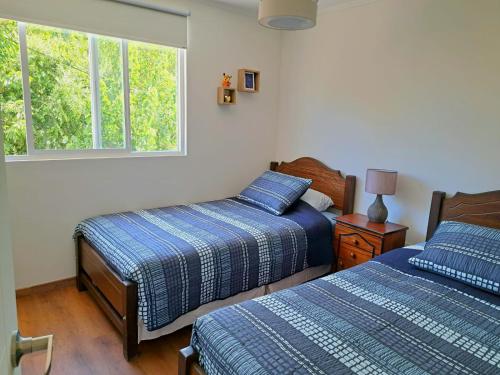 - une chambre avec 2 lits et une fenêtre dans l'établissement Hogar Entre Viñas, à Casablanca