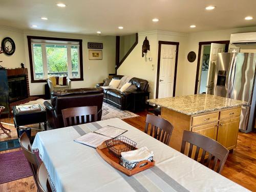 a kitchen and living room with a table and a kitchen and a living room at Avenue of the Giants River View Home (#1) 