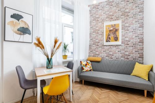 a living room with a couch and a table at Dragon Fruit Apartment City Center in Warsaw