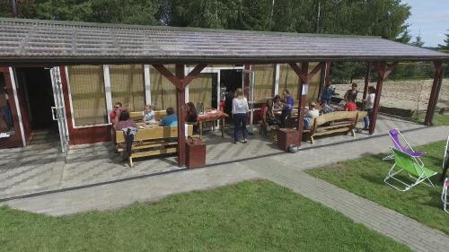 a group of people sitting in a pavilion at Sodyba Brazylija in Taraldžiai