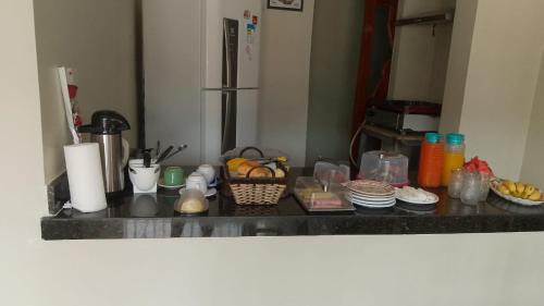 a kitchen counter top with food and dishes on it at HOTEL NOVAES in Castanhal