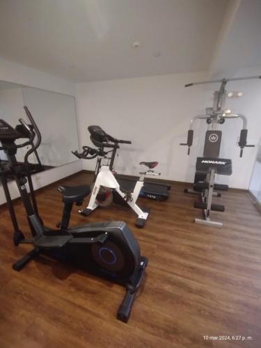 a gym with several exercise bikes in a room at Dna 44 in Lima
