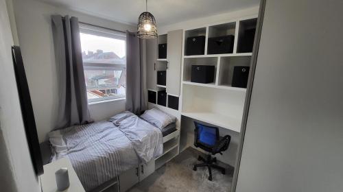 a small bedroom with a bed and a window at Luxury House Room to Rent in a 4-Bed House with Parking Short Lets  in Liverpool