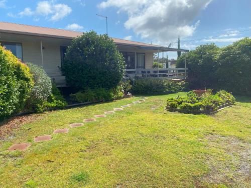 a yard with a house with some plants in it at Parnella Cottage - Pet friendly in St Helens