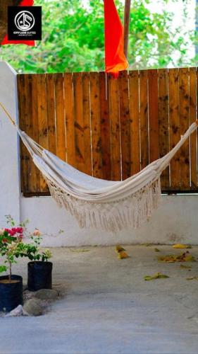 a hammock hanging in front of a wooden fence at Deleted 6 in Calayo