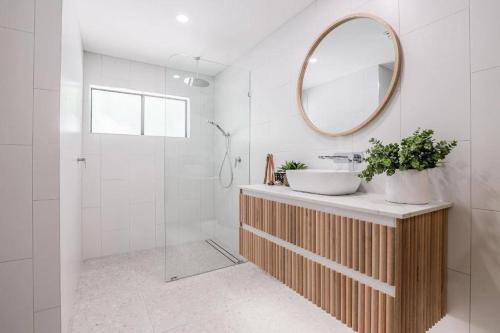 a bathroom with a sink and a mirror at Ocean Haze - Beach house in Agnes Water in Agnes Water