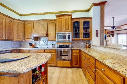 a kitchen with wooden cabinets and a granite counter top at Sunset Cove in Bridgeport