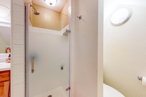 a shower with a glass door in a bathroom at Sunset Cove in Bridgeport