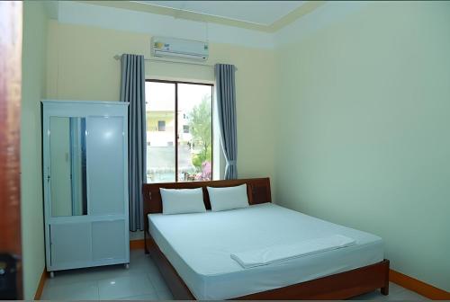 a bedroom with a bed and a window at View Nhat Le Beach Hotel in Dong Hoi