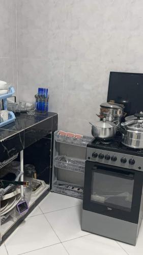 a kitchen with a stove with pots and pans on it at Best Residence in Nouakchott