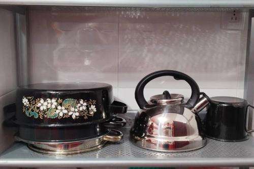 a tea kettle and a tea pot on a stove at Casa Almendros in Mexico City