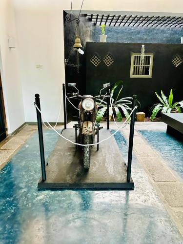 a motorcycle parked in the water in a pool at Colonial Retreat Villa in Talawatugoda