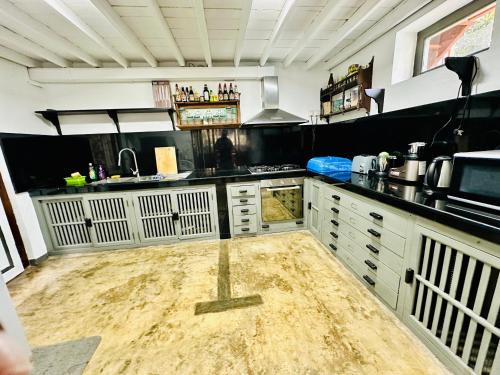 a kitchen with a dirty floor in a room at Colonial Retreat Villa in Talawatugoda