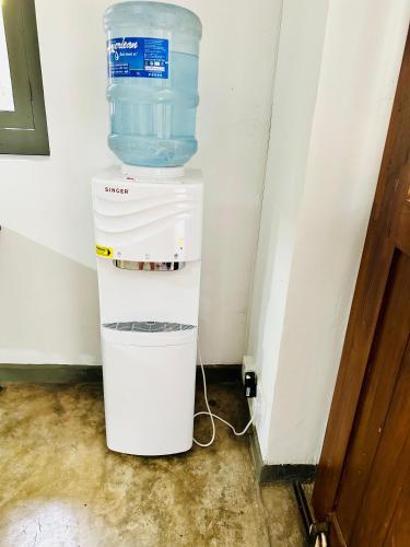 a container of water sitting in the corner of a room at Colonial Retreat Villa in Talawatugoda