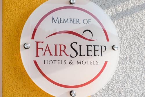 a sign for a member of far sleep hotels and motels at FairSleep Motel Einstein Erding in Erding