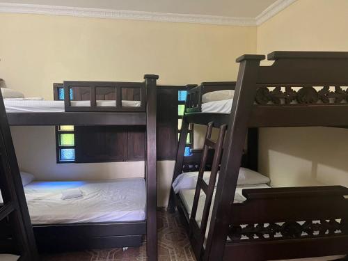 a room with three bunk beds in a room at Finca Villa Lili in Santa Fe de Antioquia