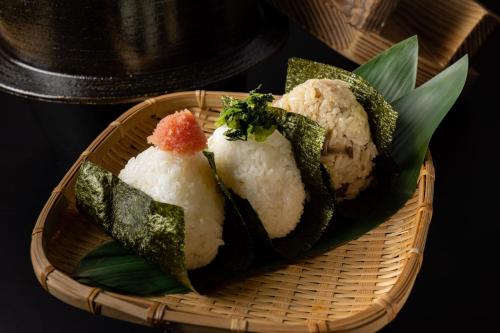 a basket with rice and vegetables on a table at Nishitetsu Grand Hotel in Fukuoka