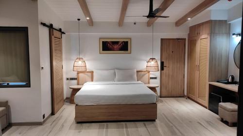 a hotel room with a bed and a television at Residency Lake Resort & Spa in Mulshi