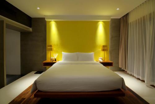 Una cama o camas en una habitación de Apsara Residence Hotel