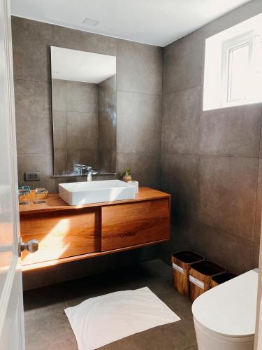 a bathroom with a sink and a mirror at Nacpan Beach Villas Managed by H Hospitality Group in El Nido