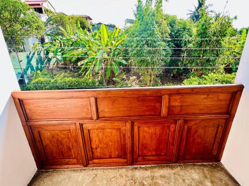 a wooden cabinet with a garden inside of it at Colonial Retreat Villa in Talawatugoda