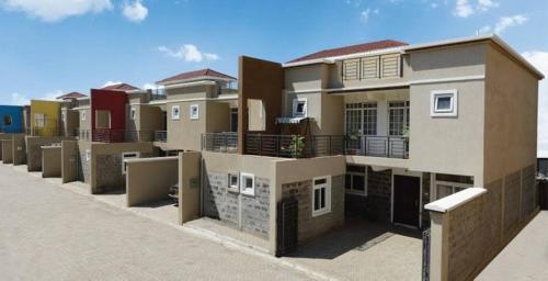 a row of houses with balconies on a street at Js apartments in Narok