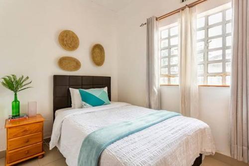 a bedroom with a large bed and a window at Js apartments in Narok